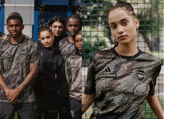Camisa Pré Jogo 2023/24 em Colaboração com Maharishi, apresentando padrão de camuflagem 'DPM: Bonsai Dragon Scales'. Gola pólo preta, logotipo Adidas e escudo do Arsenal em preto e bege.